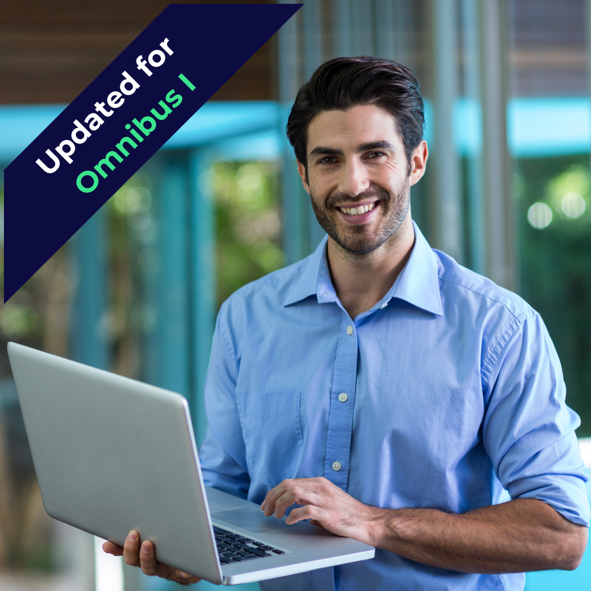 Professional man standing with a laptop in his hands smiling at the camera