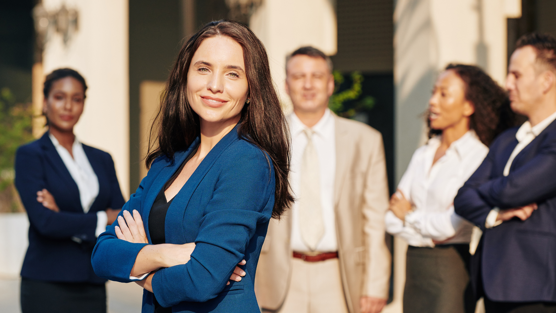Team of professionals looking at a whiteboard while one presents in an office