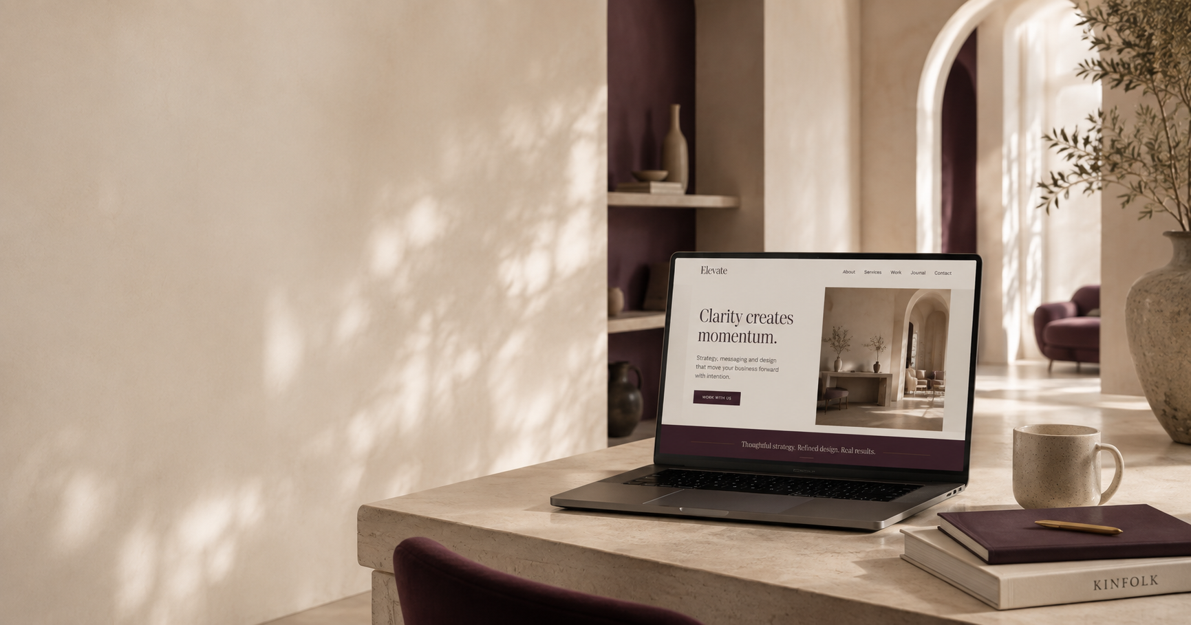 Elegant website displayed on a laptop in a warm editorial workspace