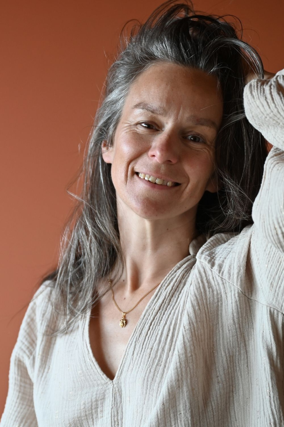 Warm, smiling portrait of Laurence Tison welcoming high-achieving women to connect and begin their somatic journey back home.