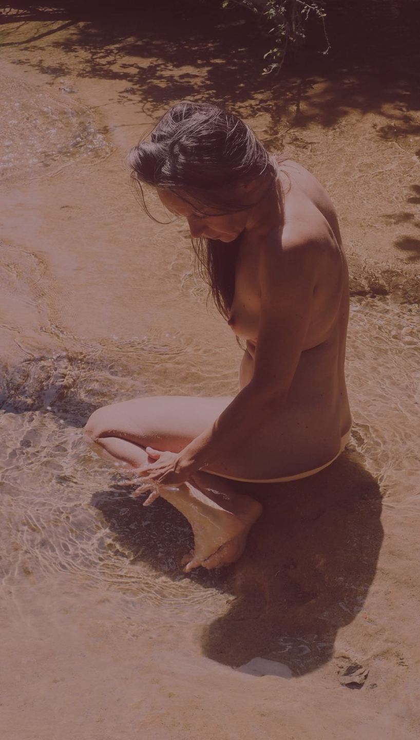 Laurence Tison in natural water, embodying fluidity and the feral nature of feminine power.