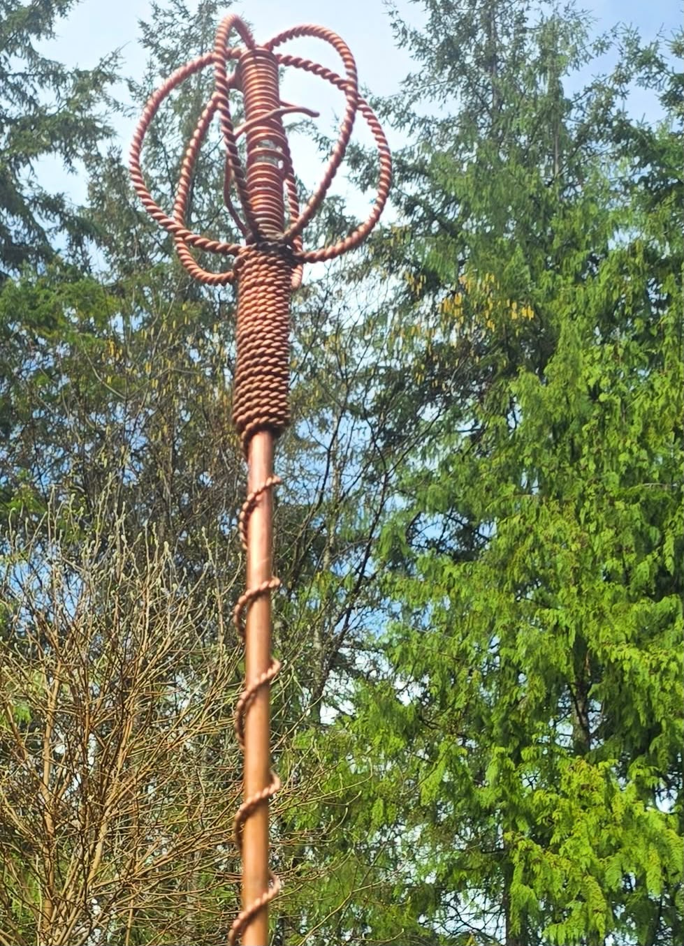 A full-height Homestead Harmonizer Antenna System against the cedars