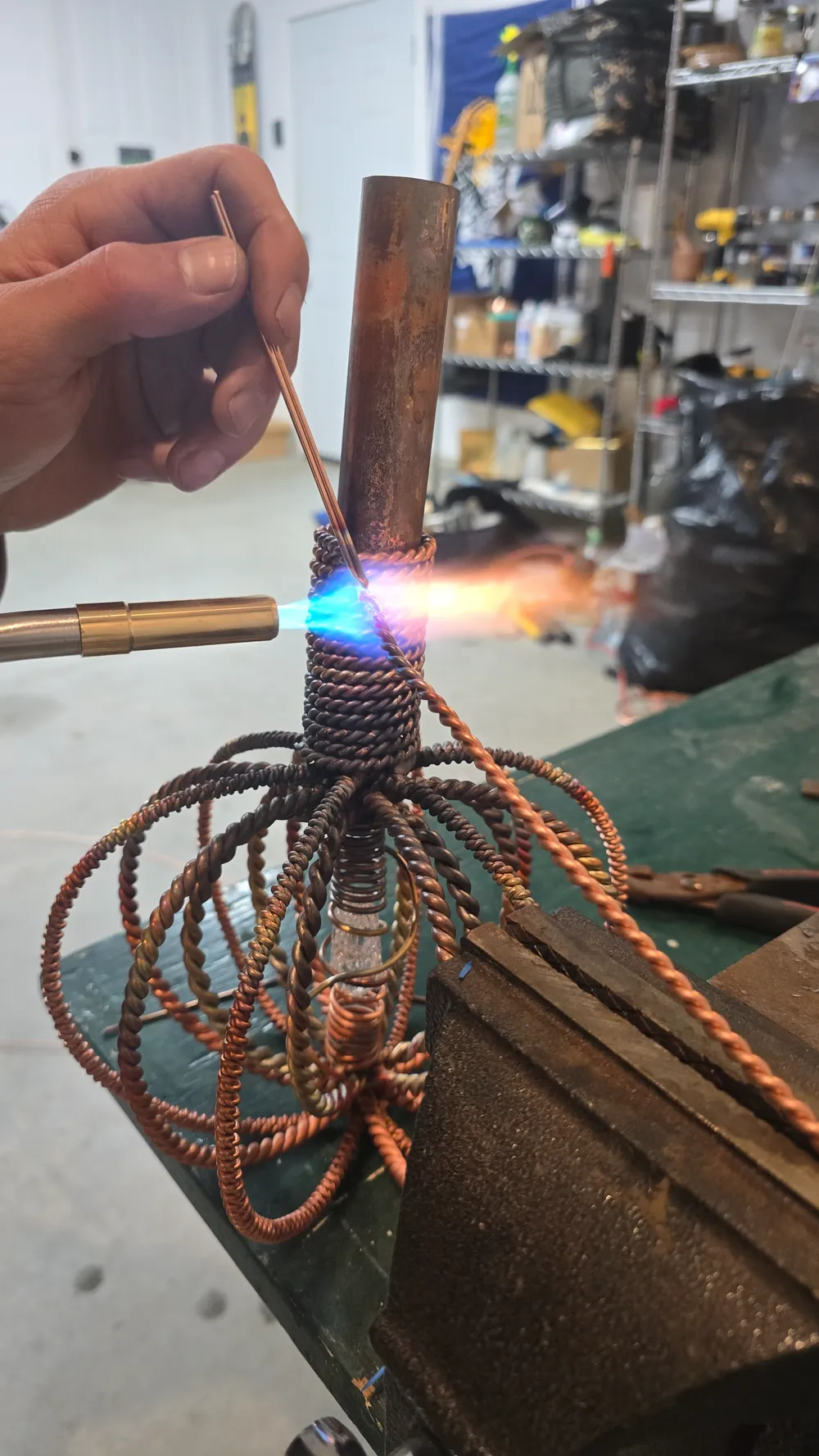 The copper crown of a Harmonizer Antenna System being forged by hand with a torch