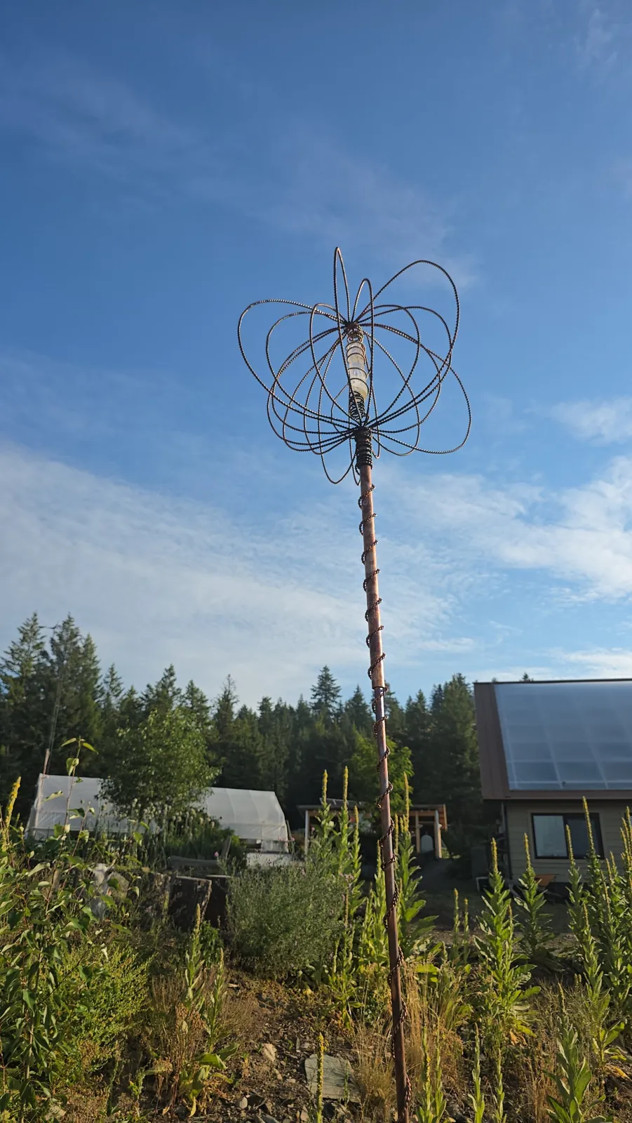 A Harmonizer Antenna System rising above the garden in front of the homestead
