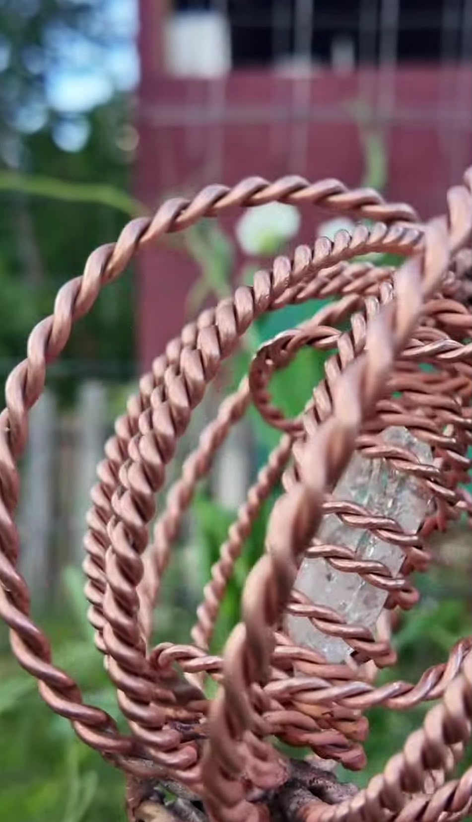 The woven copper crown of a Homestead Harmonizer Antenna System around its quartz heart