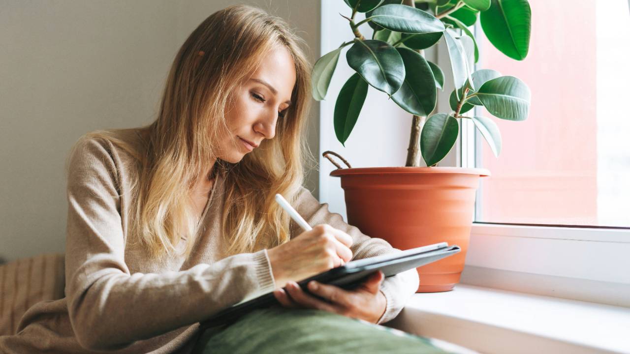 Woman recording symptoms of herself