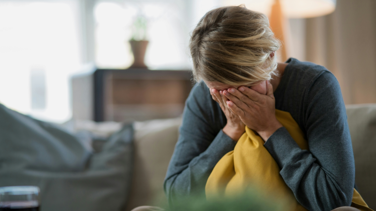 Woman frustrated with herself, head in hands