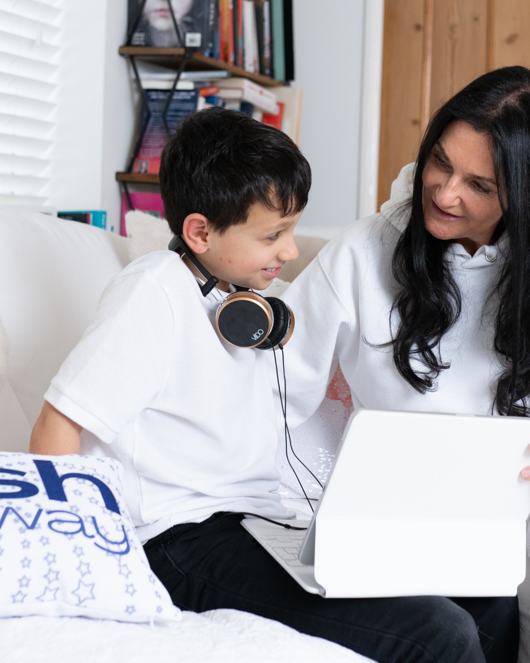 Nicola listening with a child wearing headphones