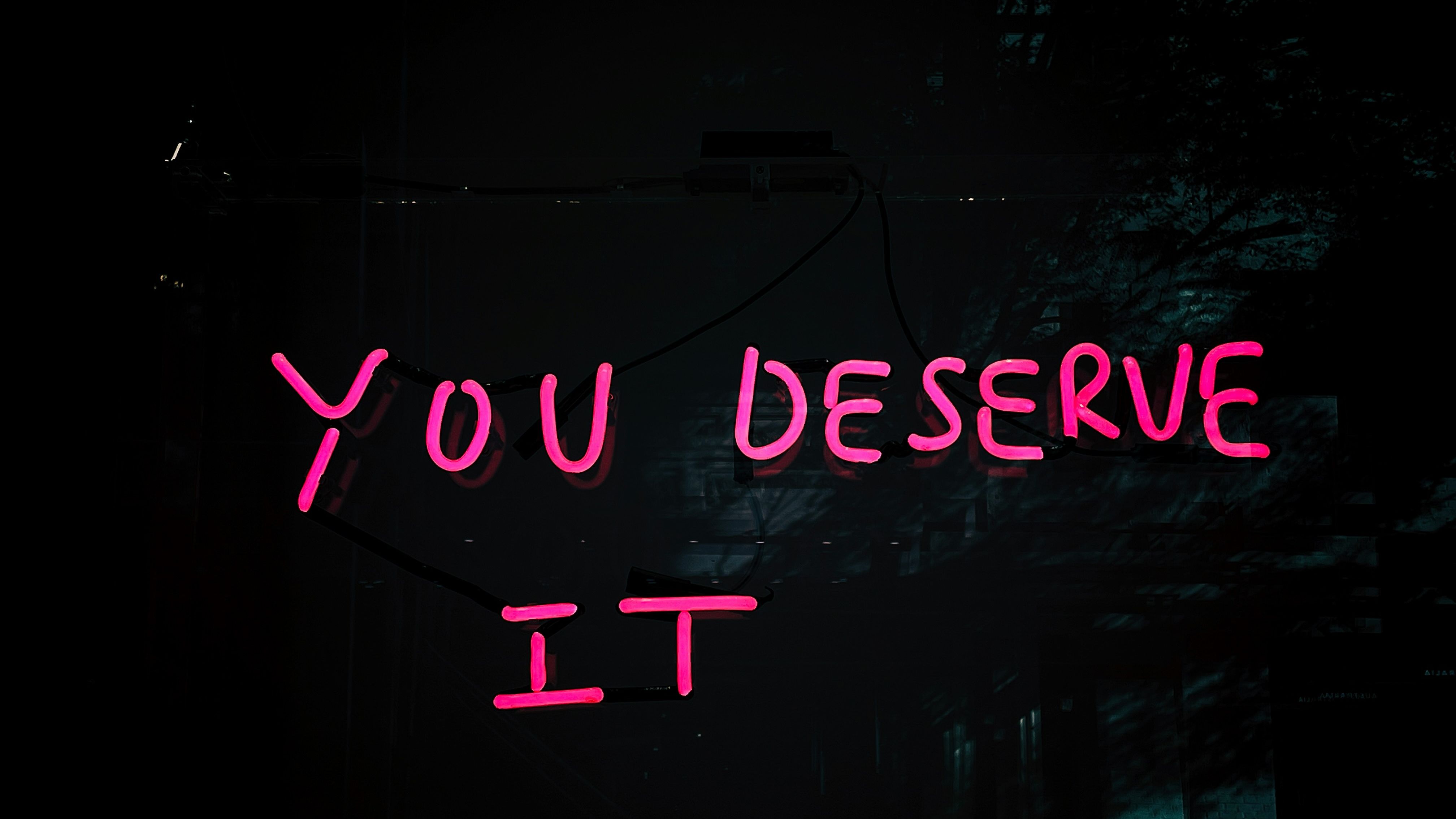 black background with pink writing saying you deserve it