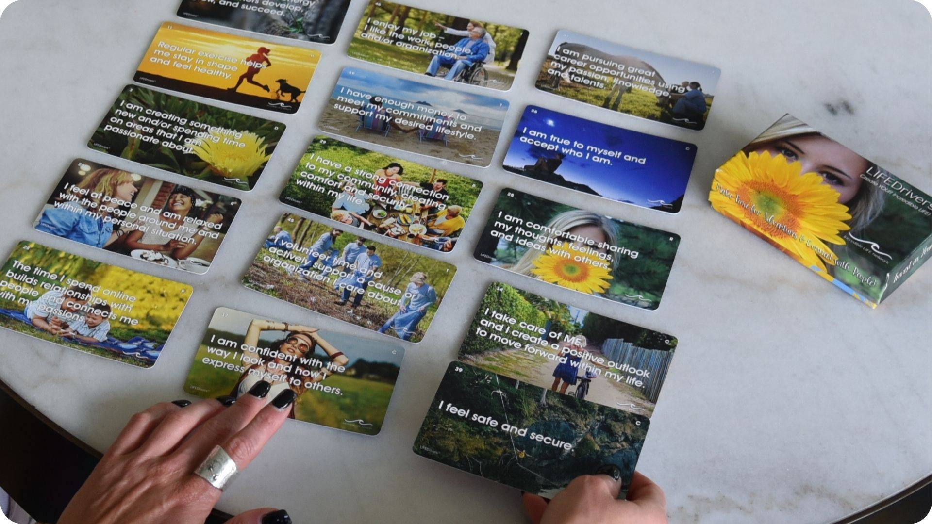 LIFEDriver cards laid out on a table, each printed with a personal value or motivator to help identify what drives you