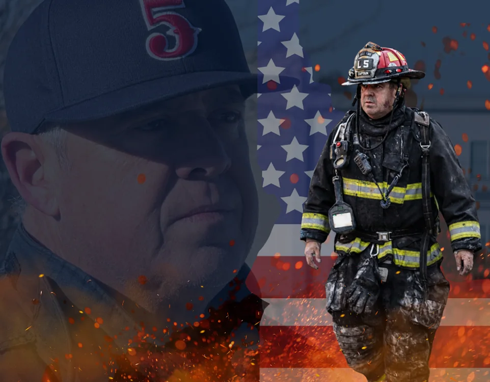 Rob in his number 5 cap, and a firefighter in turnout gear walking out of a fire, over the American flag