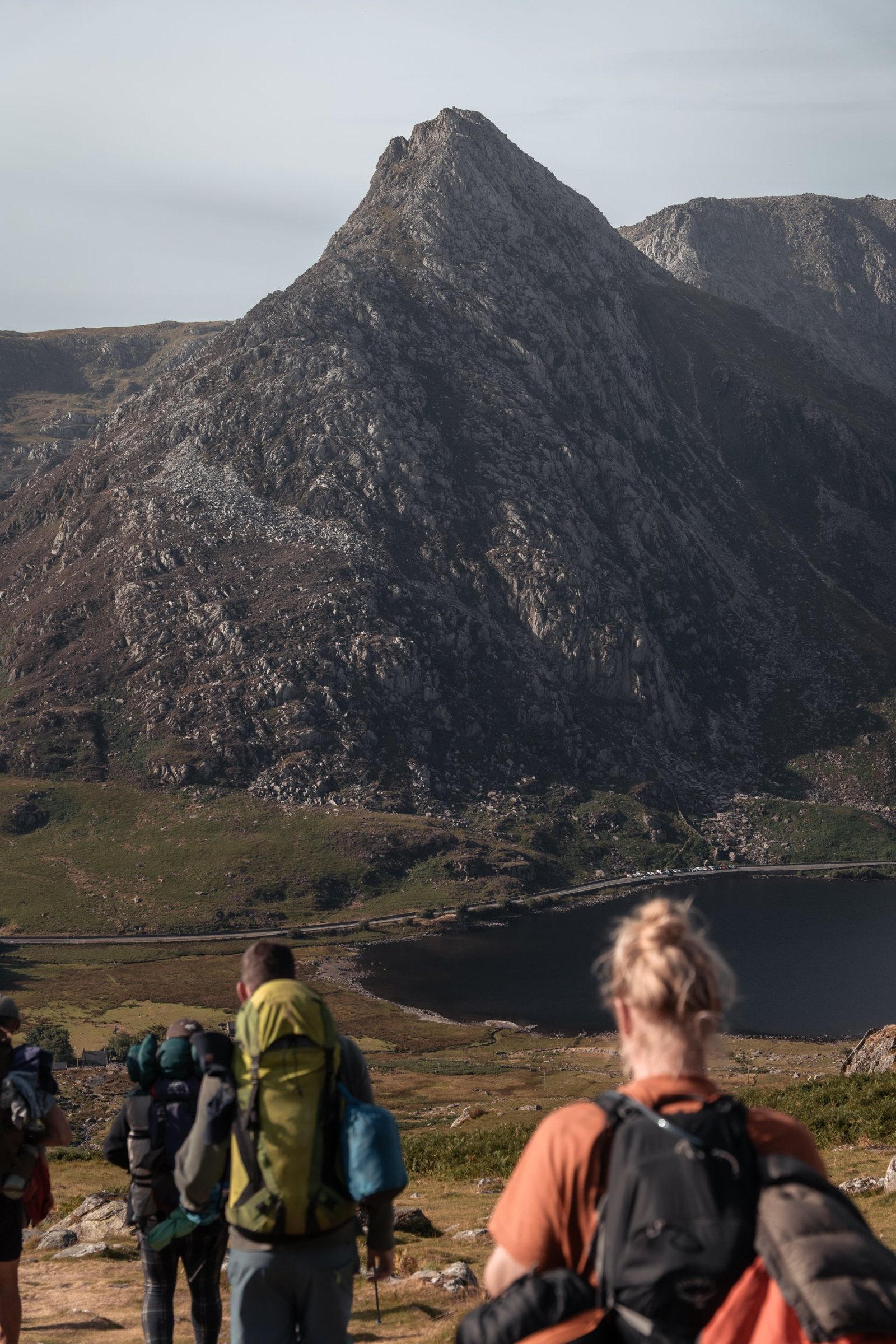 Men of Earth hikers looking up at Tryfan above Llyn Ogwen