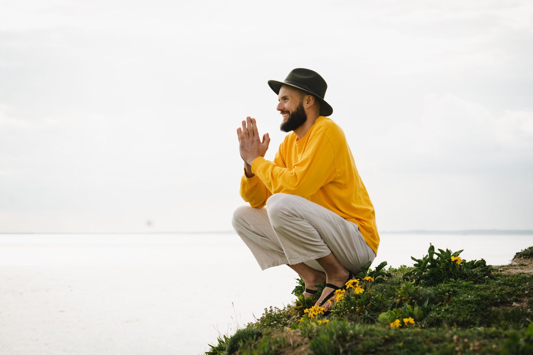 Chris Geisler smiling on a clifftop by the sea