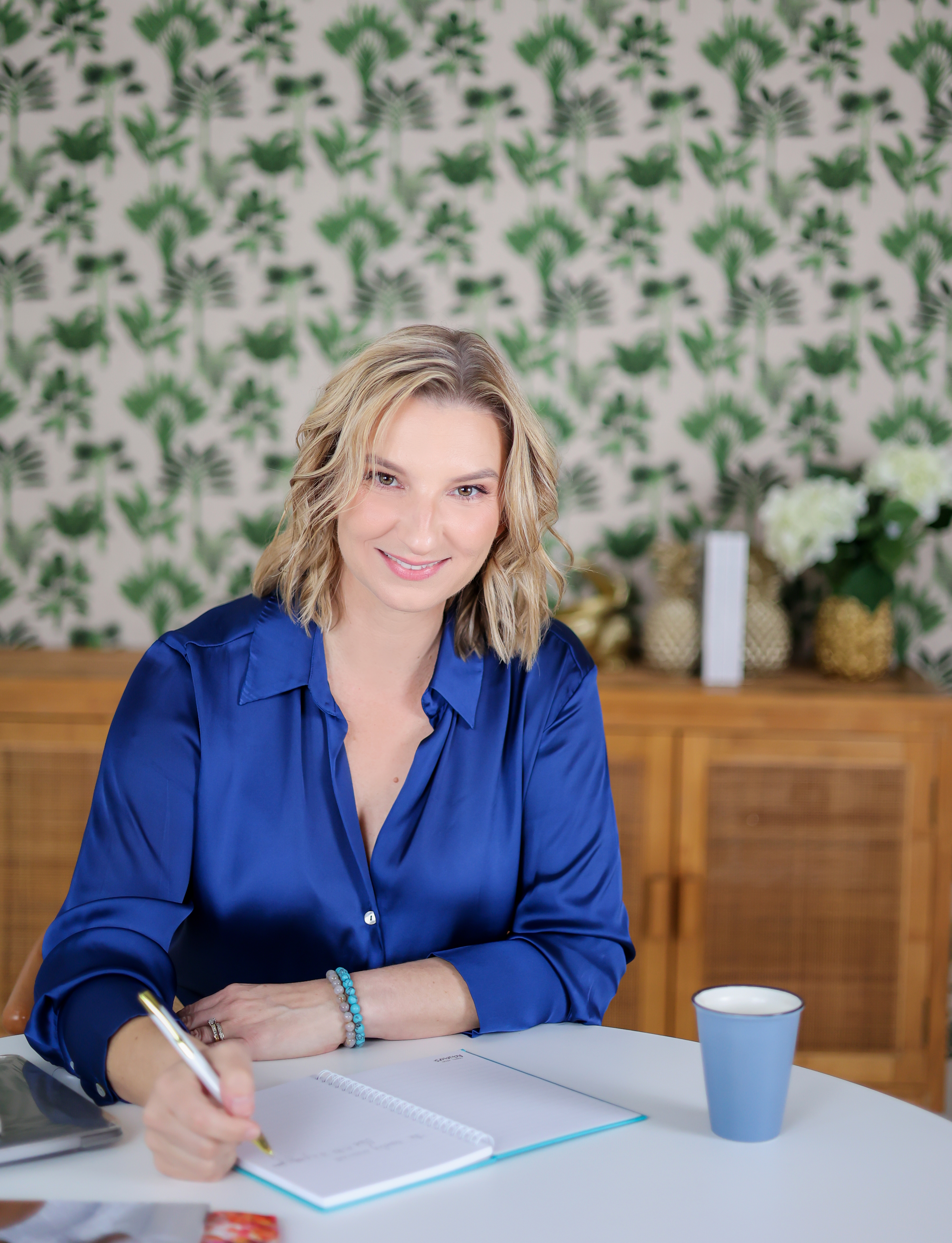 Roslyn Ranse, travel advisor and founder of Travel Agent Achievers, writing in a notebook at her desk