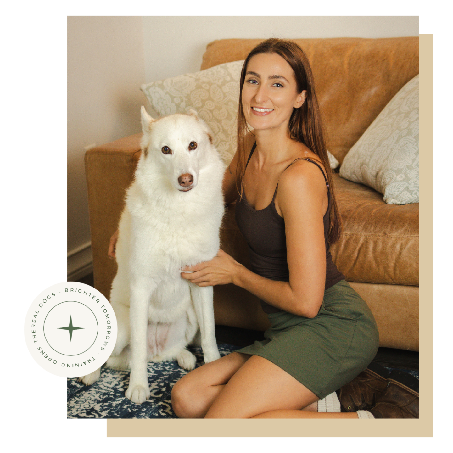 Savanah sitting on a leather couch with a white dog at her side