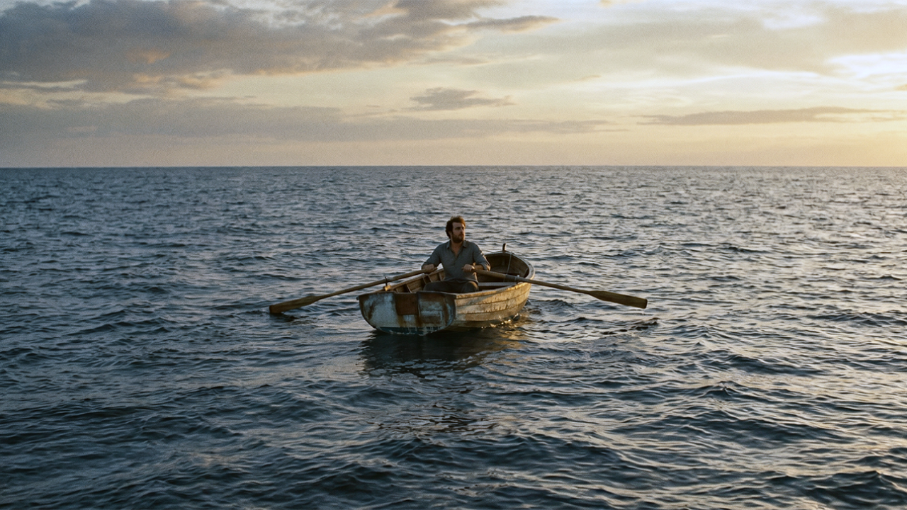 Man drifting in a boat.