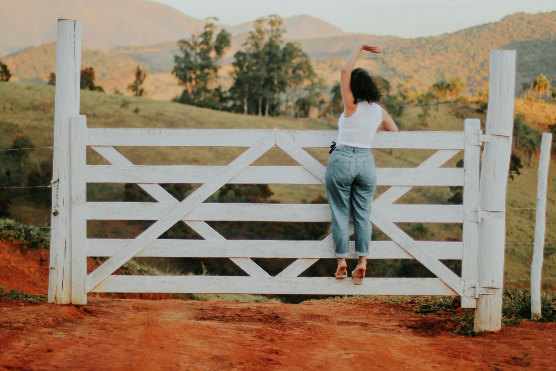 woman happy on a gate in the Australian landscape