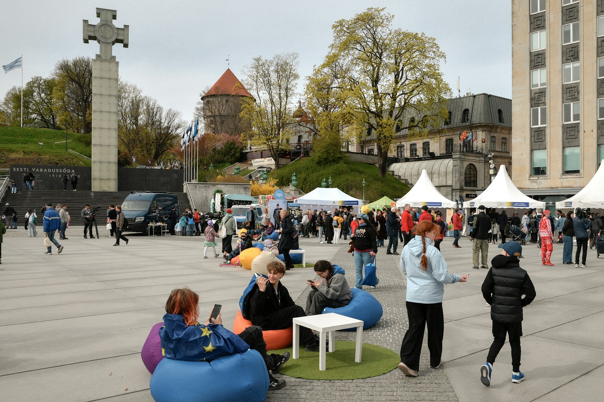 People lounging and wandering through a festival square