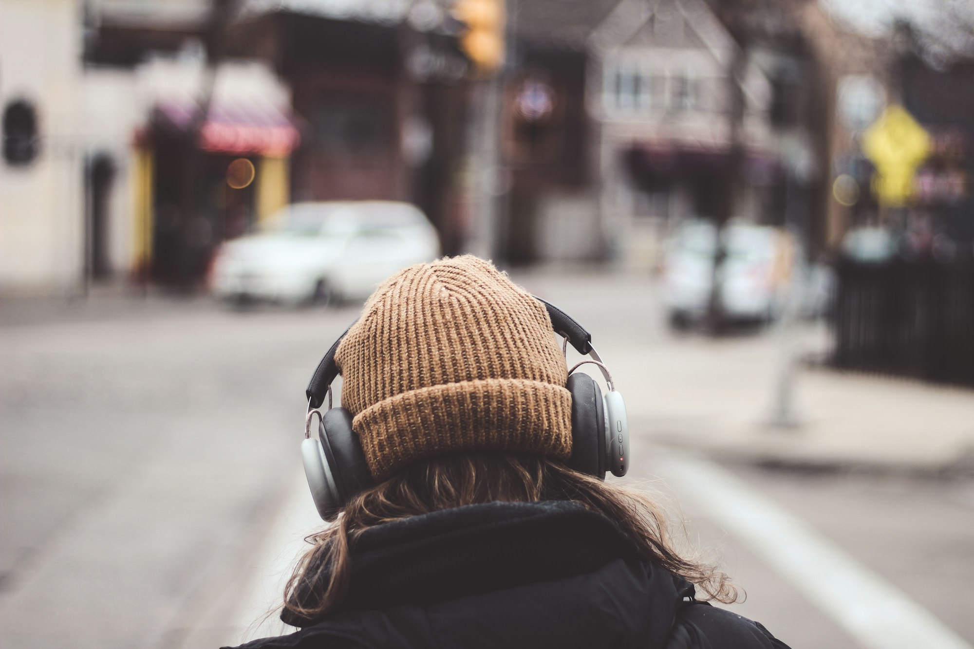 A person in headphones listening to a podcast