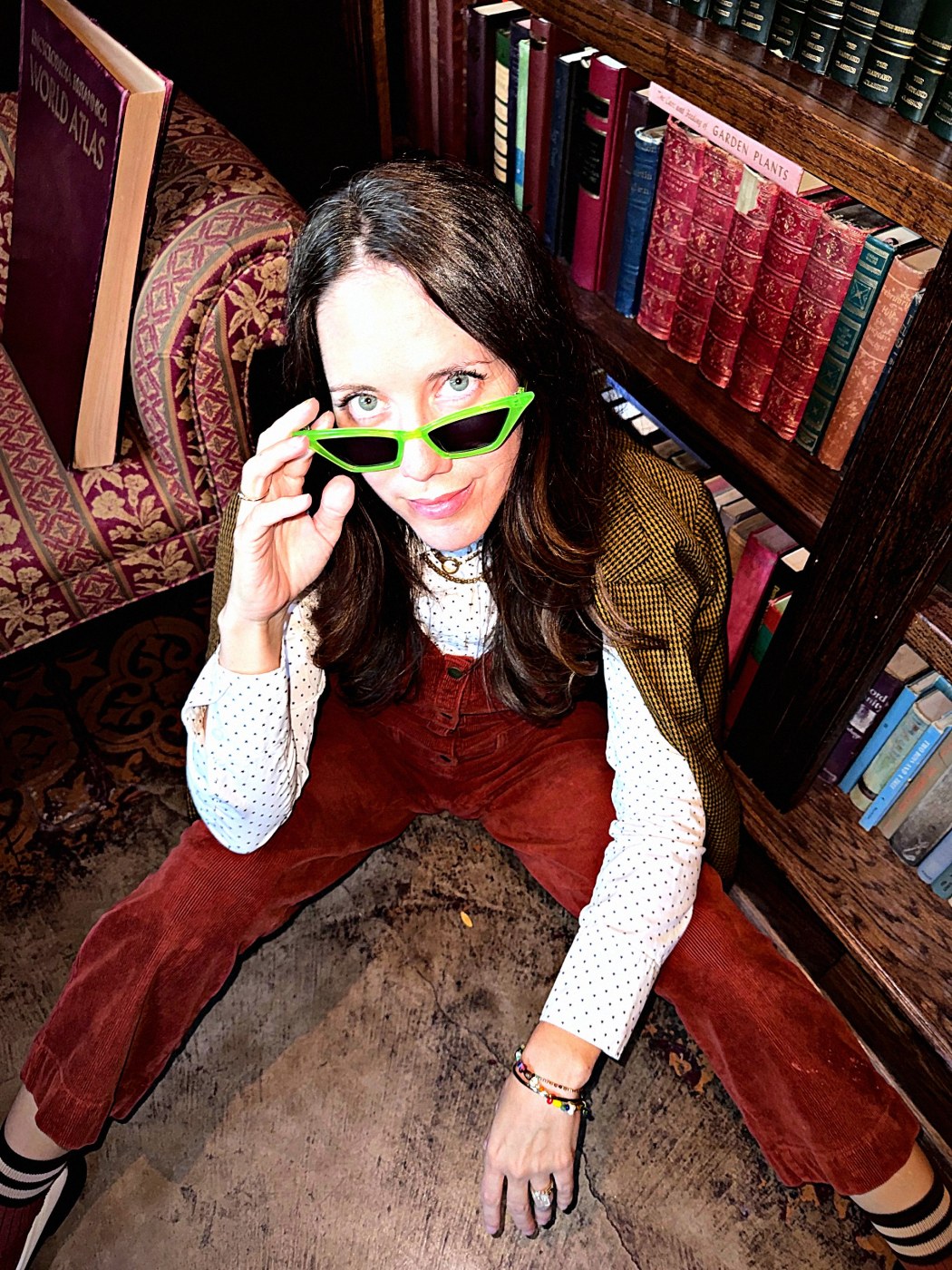 Tamra peeking over lime cat-eye sunglasses