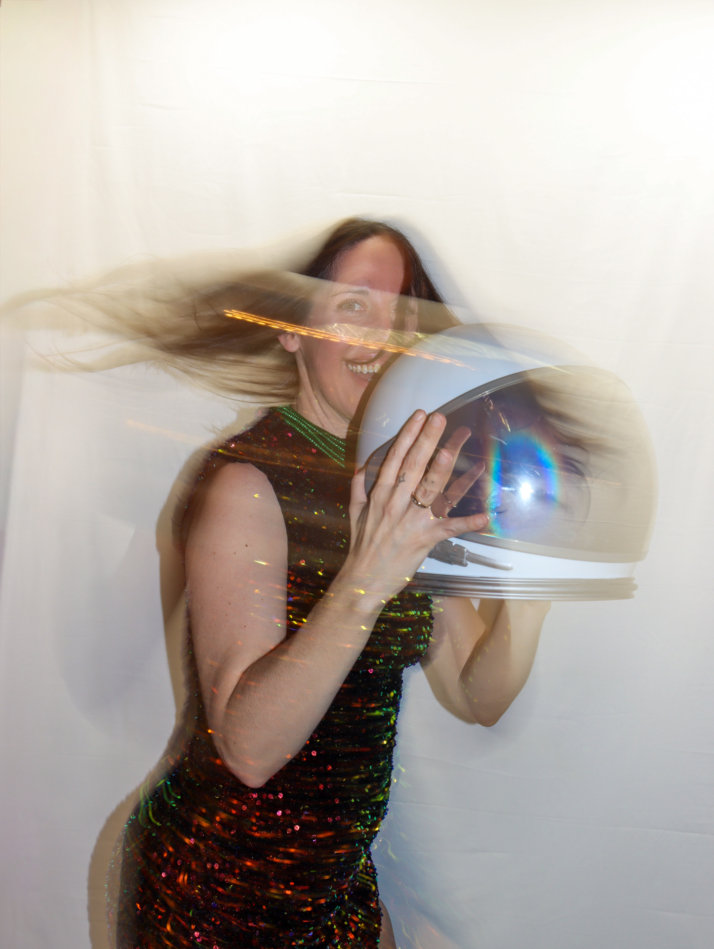 Tamra mid-spin in a sequined dress and a space helmet