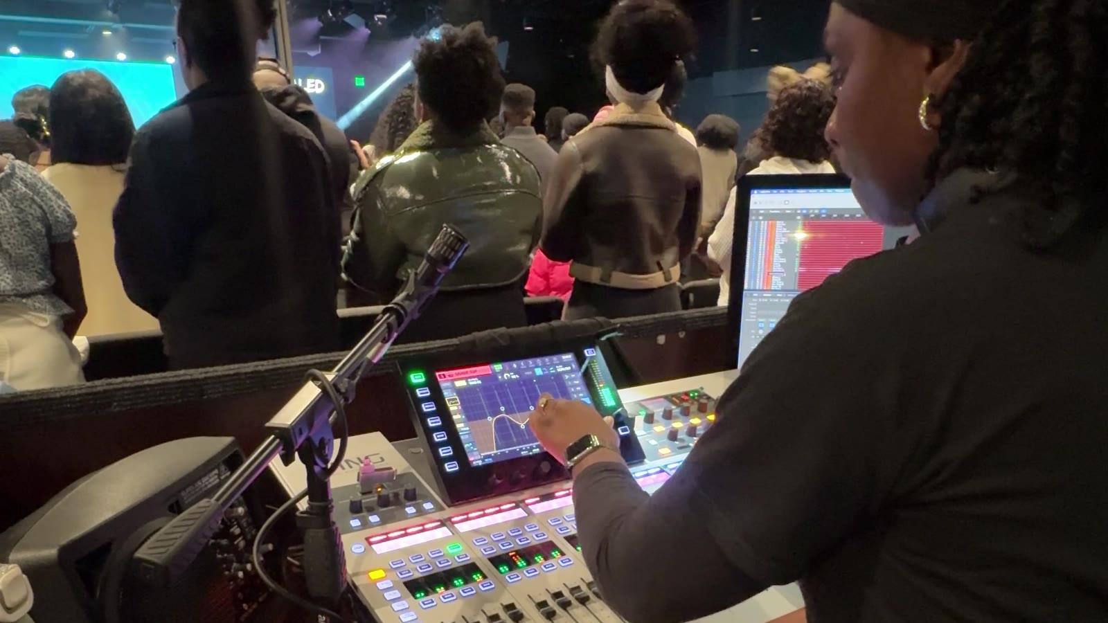 Tobi Mark mixing live sound for a full church audience