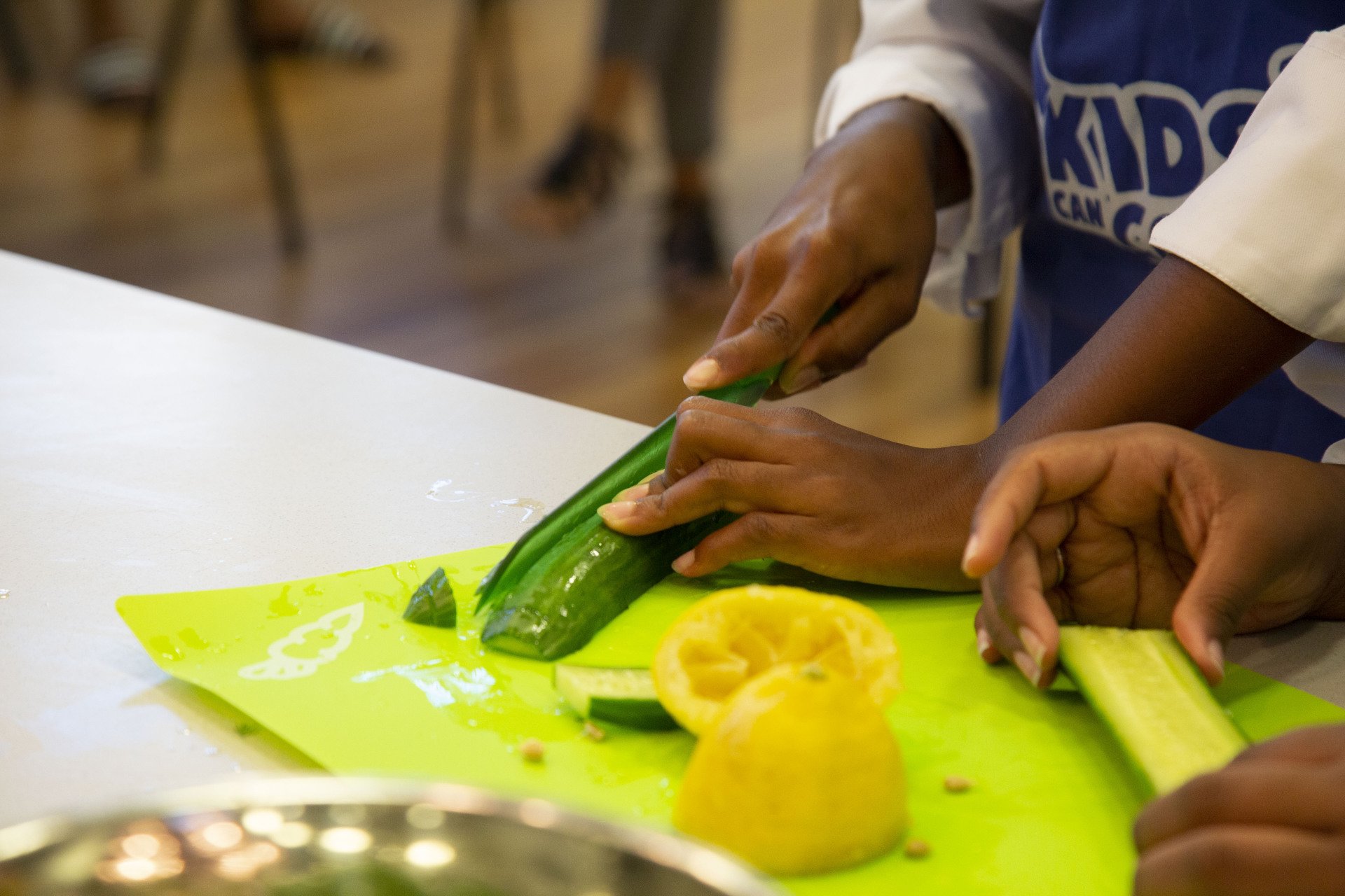 Children cooking and chopping vegetables