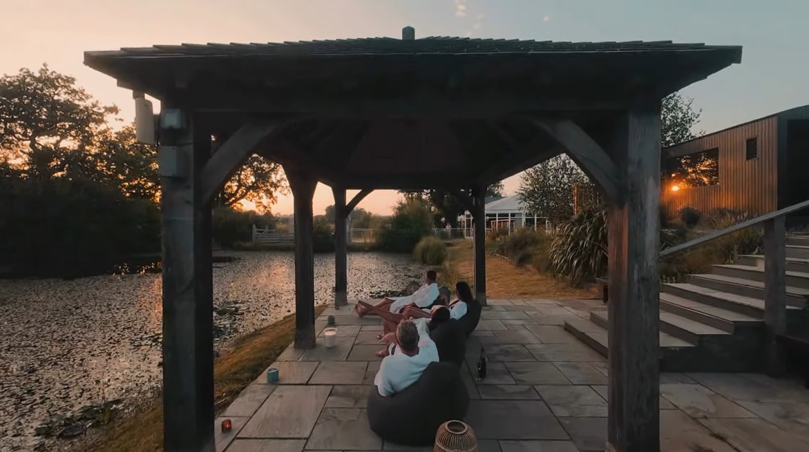 Relaxing in robes in the gazebo at sunset, Gower Retreats