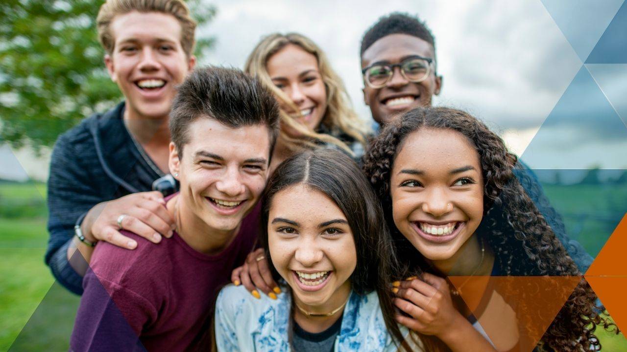 teen friends huddled up laughing for a photo
