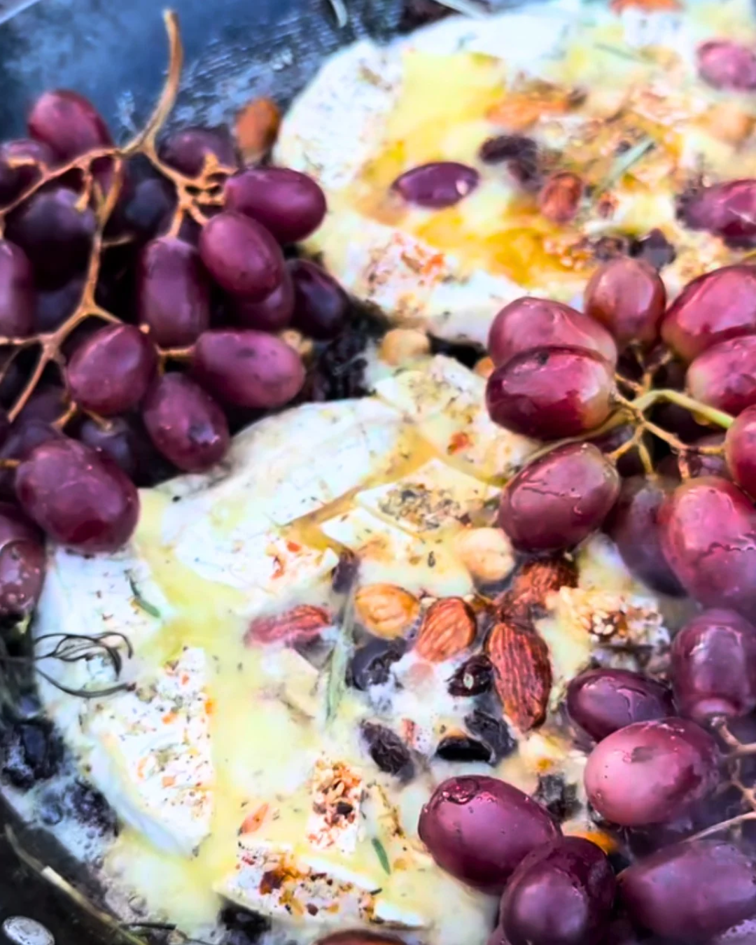 Fire-roasted grapes with melted brie, almonds and olive oil