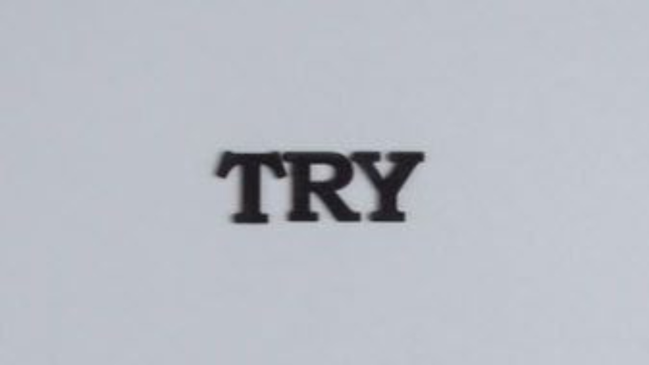 The word TRY in bold black letters on a plain light gray background