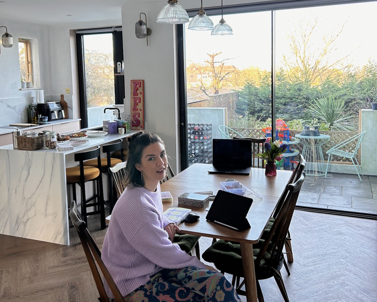 Amy Lord at her kitchen table with her laptop, running her small business with Claude AI