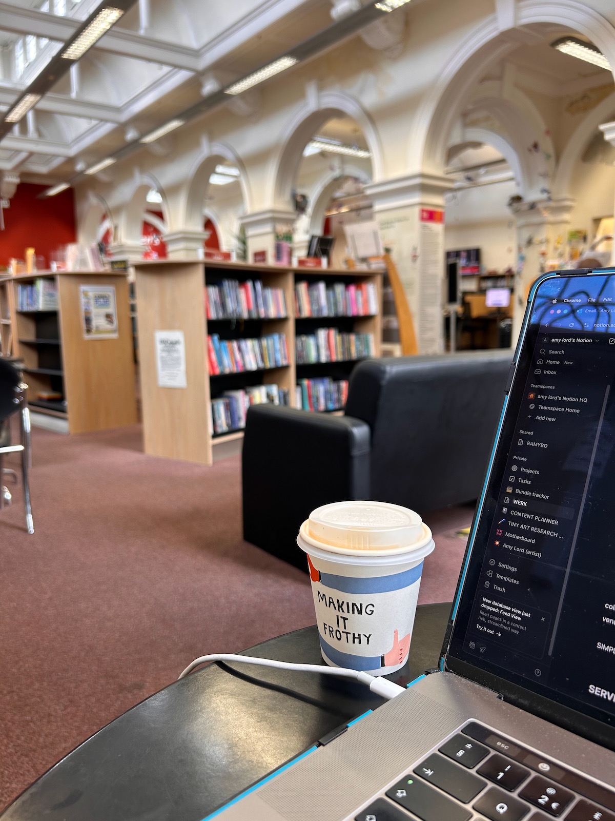 Laptop and coffee cup in a quiet library