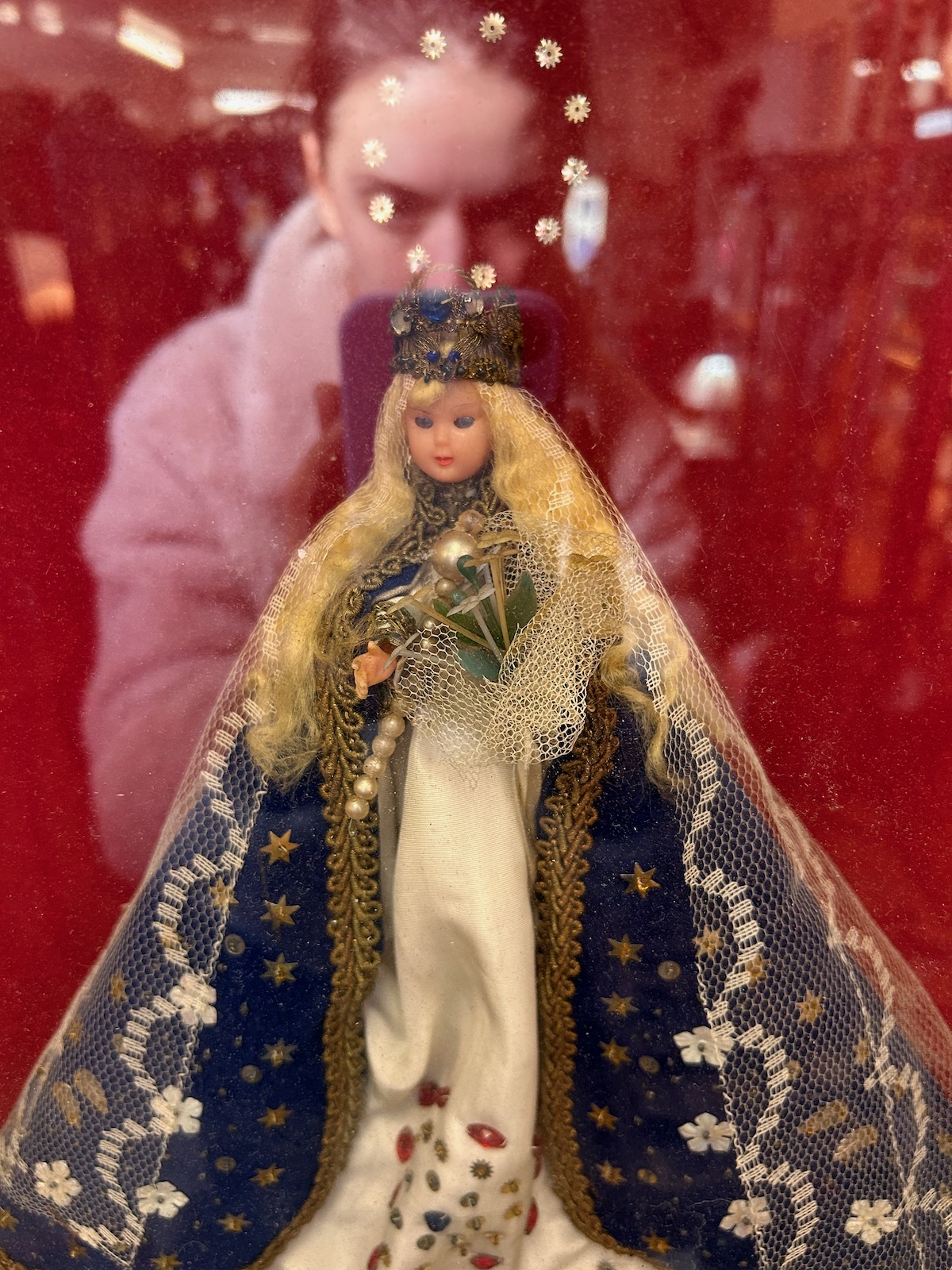 Kitsch doll in a display case on an artist's date, finding your creative mojo