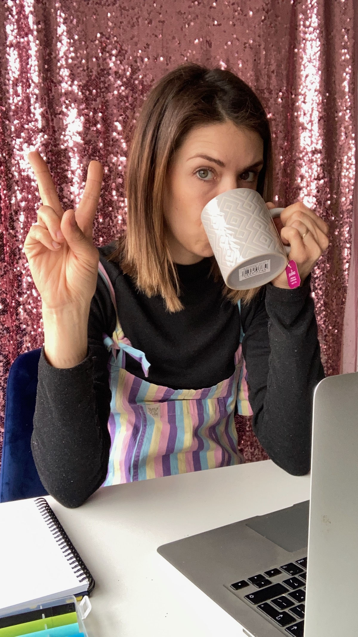 Amy Lord, business coach for creative female founders, with a coffee at her laptop