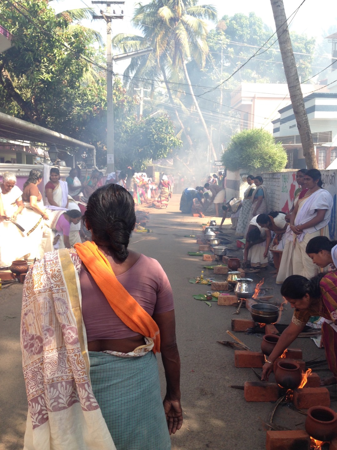 Women preparing offerings for blessings and wellbeing during Attukal Pongala, Thiruvananthapuram.