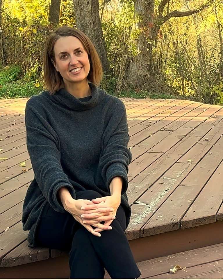 Dr. Jen Harsh sitting outside in autumn
