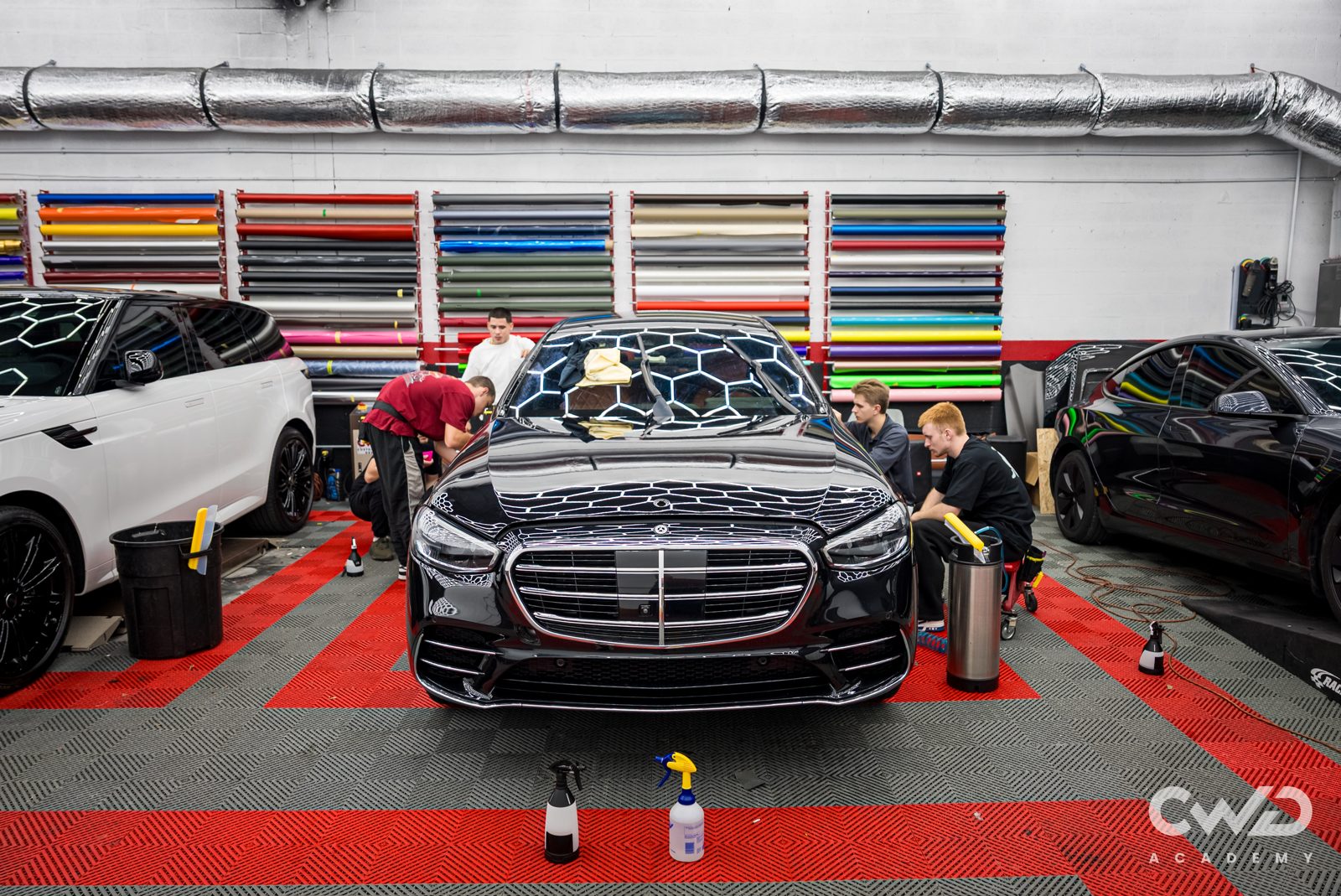 Students working on a Mercedes during a class at the CWD shop in Miami