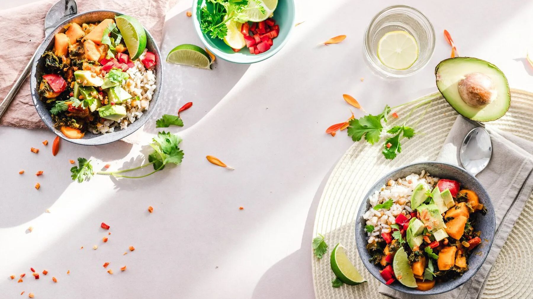 Colorful bowls with vegetables, grains, and avocado