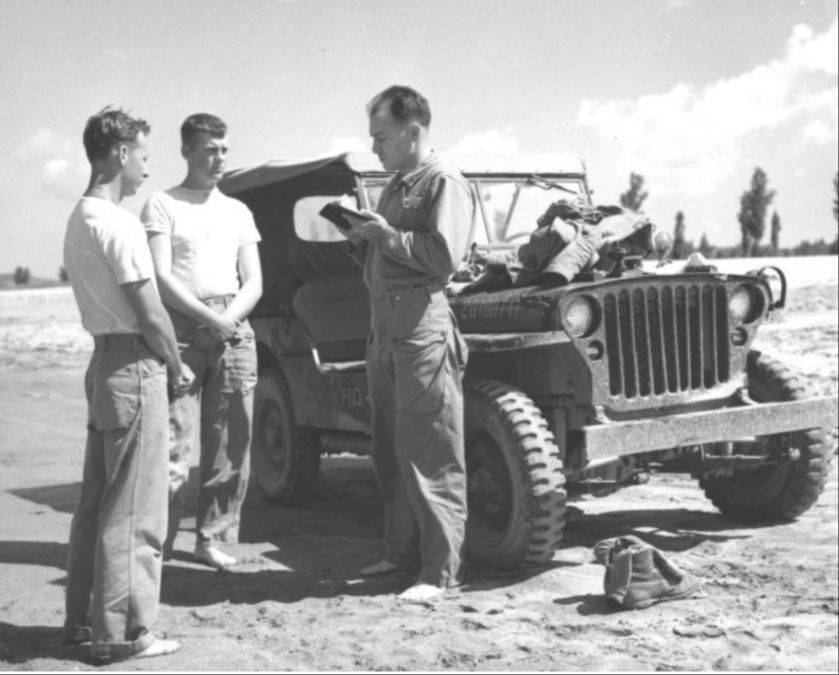 Marines receiving instructions from Chaplain A. D. Prickett prior to baptism in the Imjin River