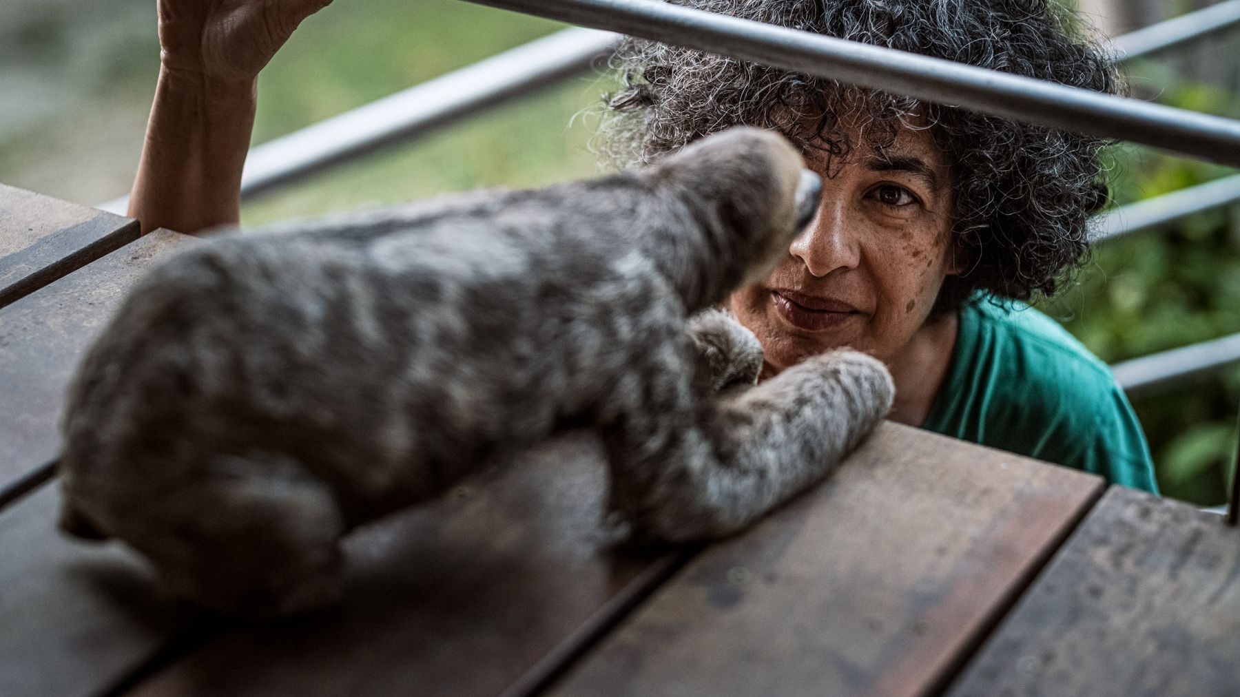 Monique with a rescued sloth at her conservation center in Suriname