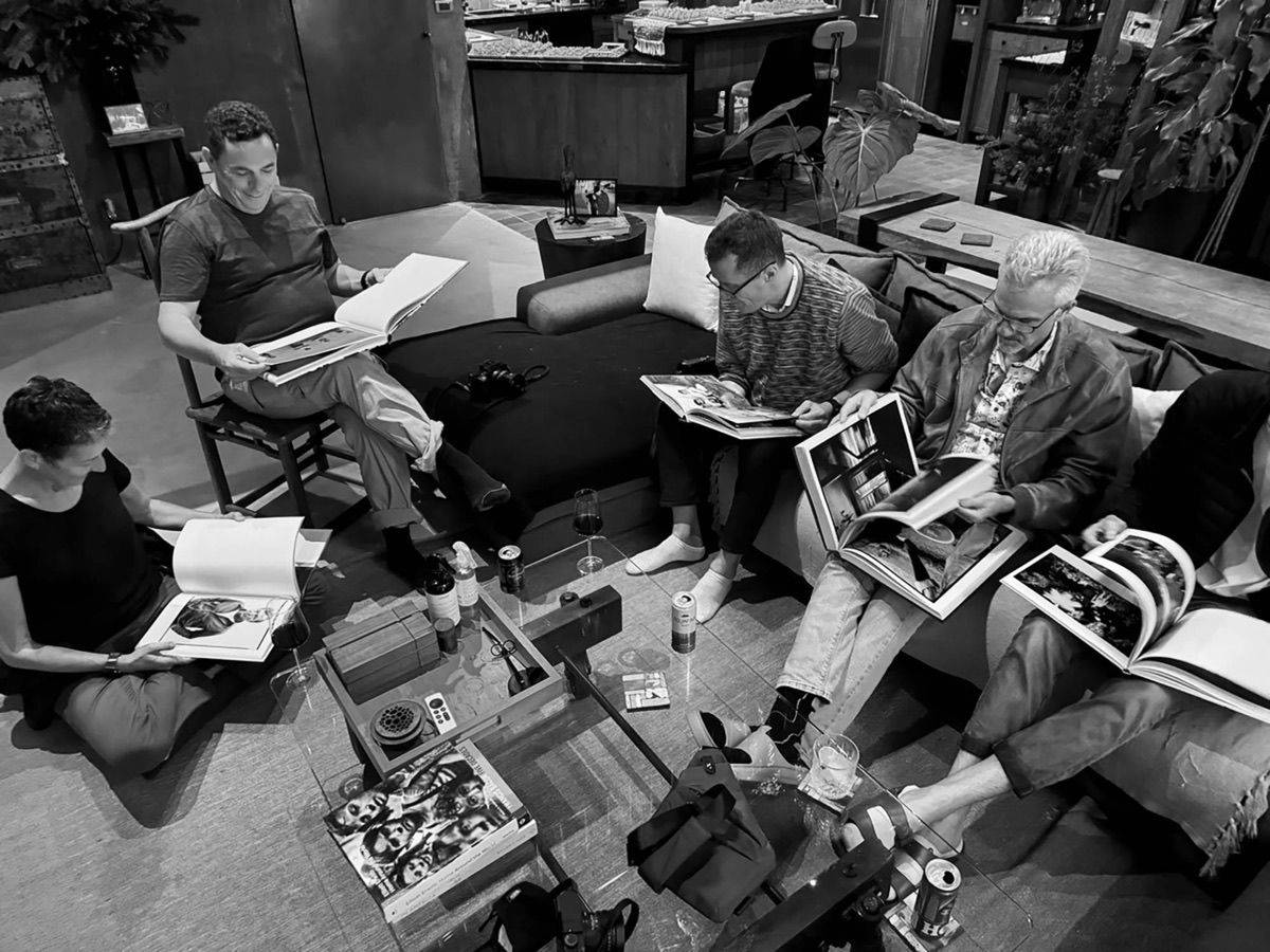 AskMott members reviewing photography books during a group critique