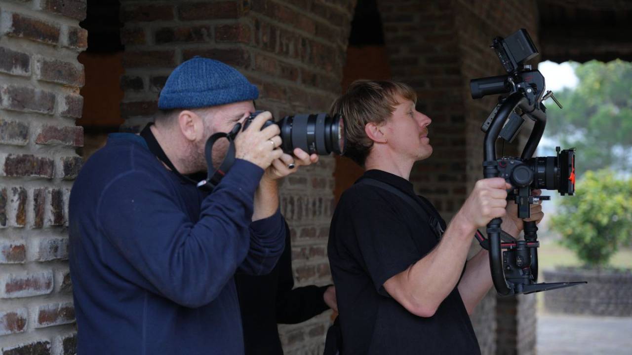 Justin Mott photographing stills alongside a cinematographer on a commercial video shoot
