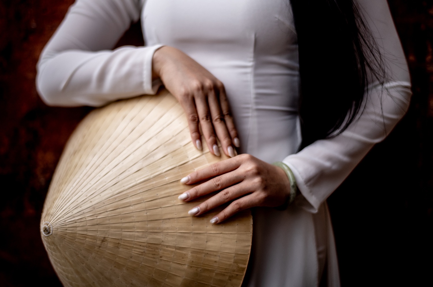 Hands holding a conical hat