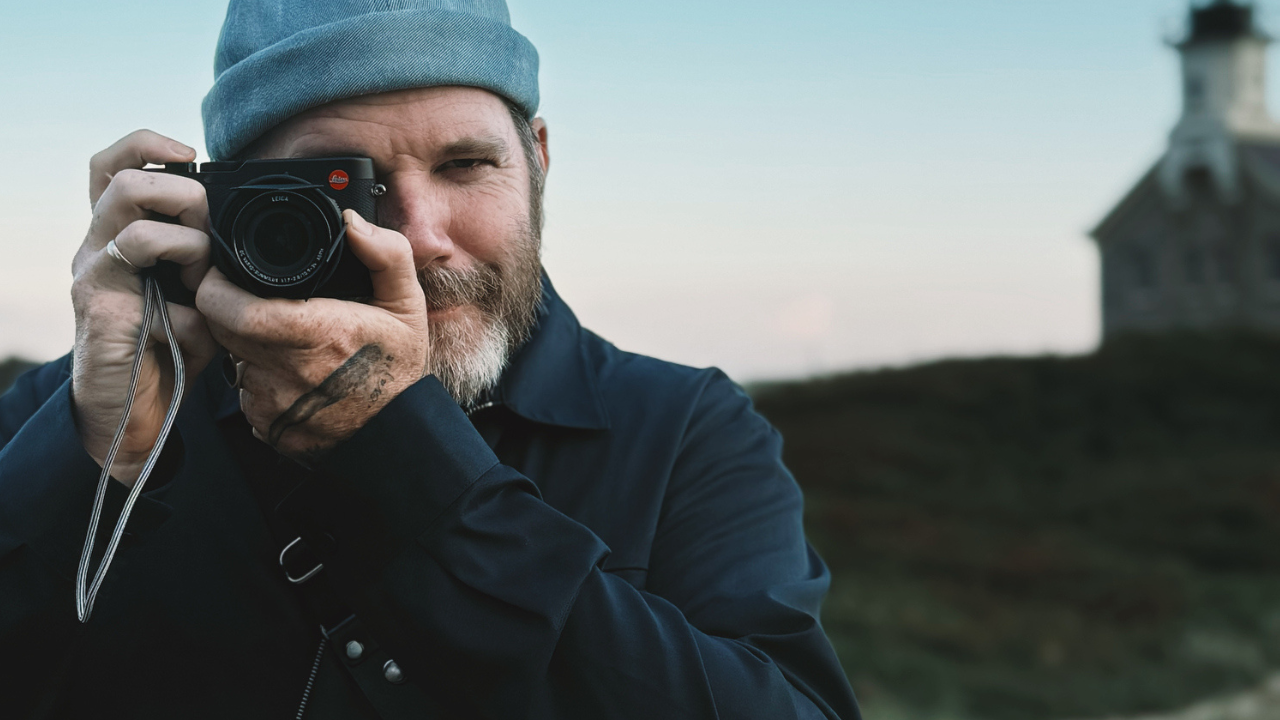 a photo of Photogrpaher Justin Mott holding a Leica on Block Island, Rhode Island