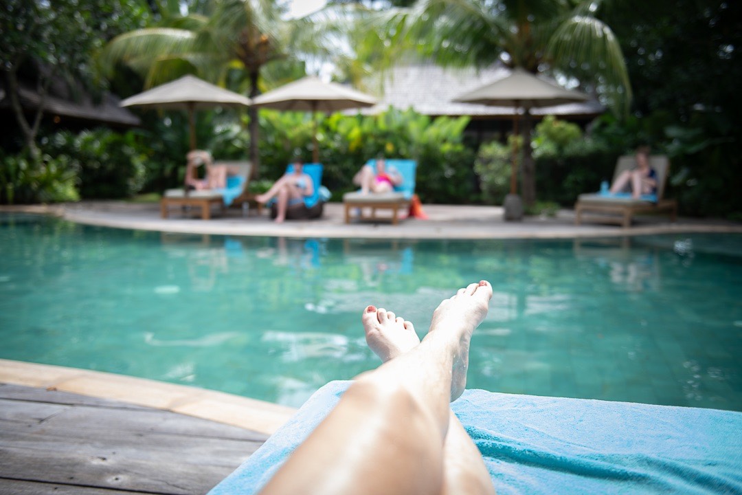 A woman resting peacefully in a hammock by the water, a picture of stillness and rest