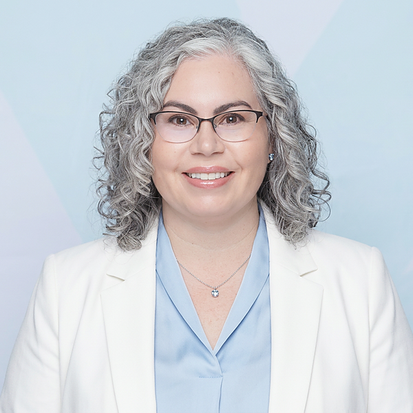 Emily Egley, Board-Certified Patient Advocate, smiling headshot in a white blazer