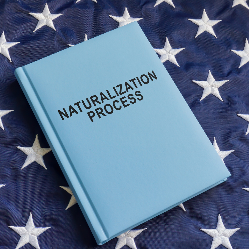 Book on USA flag showing the Naturalization test process