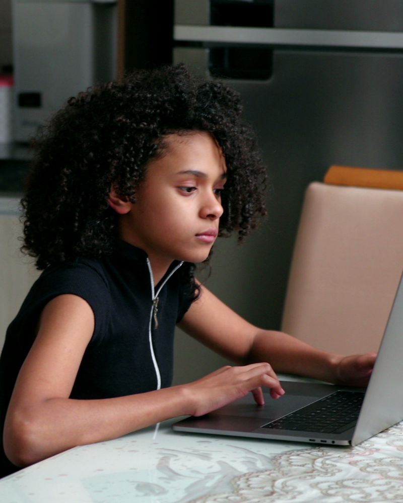 8th grade student taking the SHSAT Prep Course on her laptop at home