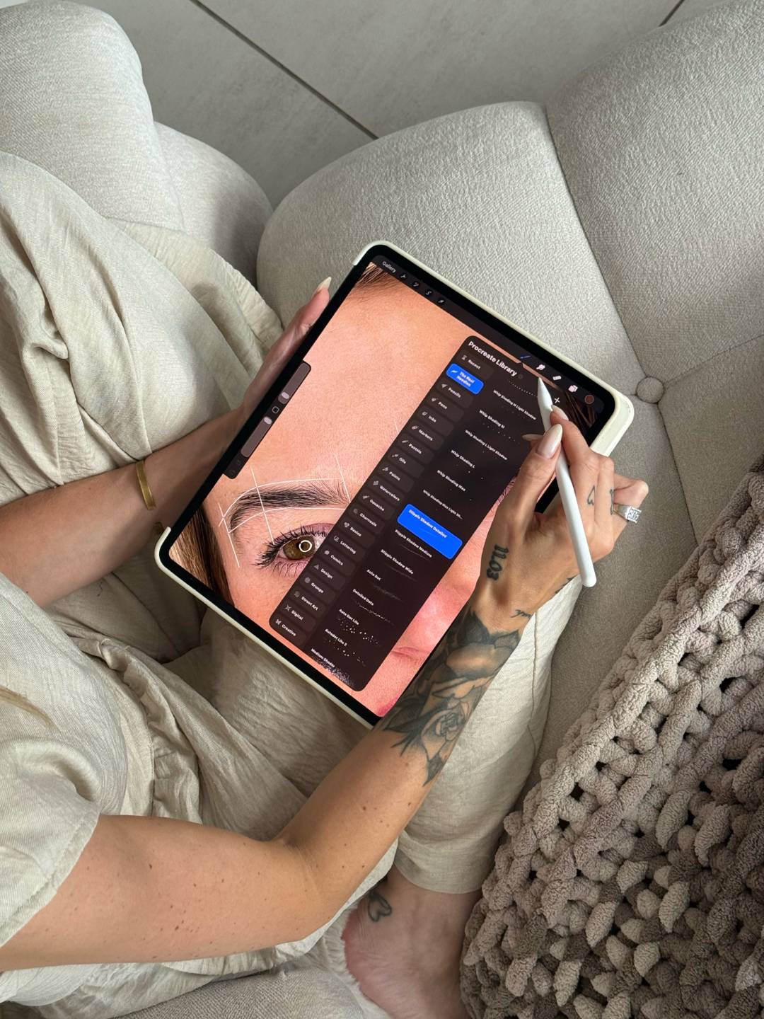 Brow artist using Procreate on an iPad to design a brow pattern